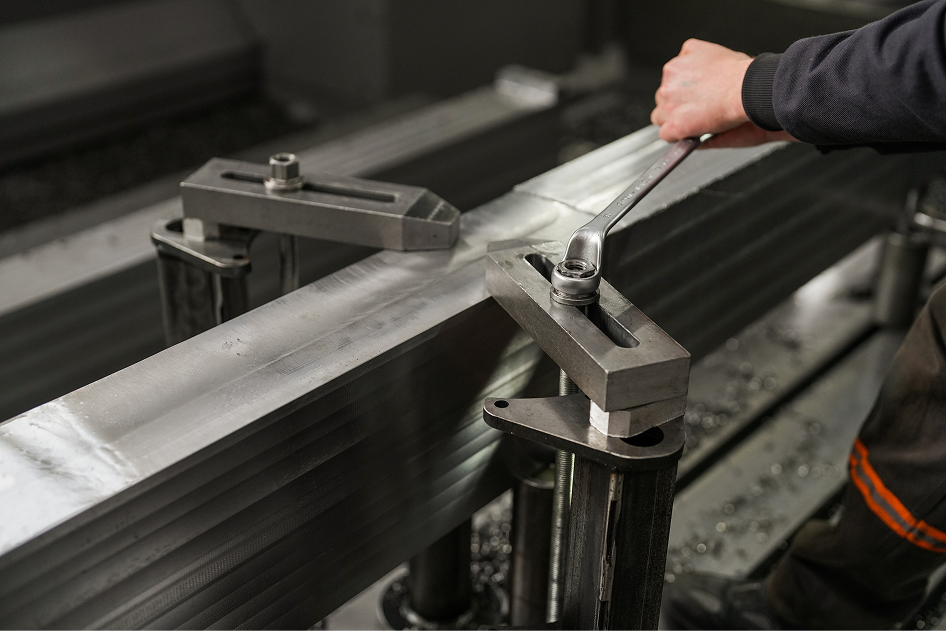 worker tightens industrial fastener